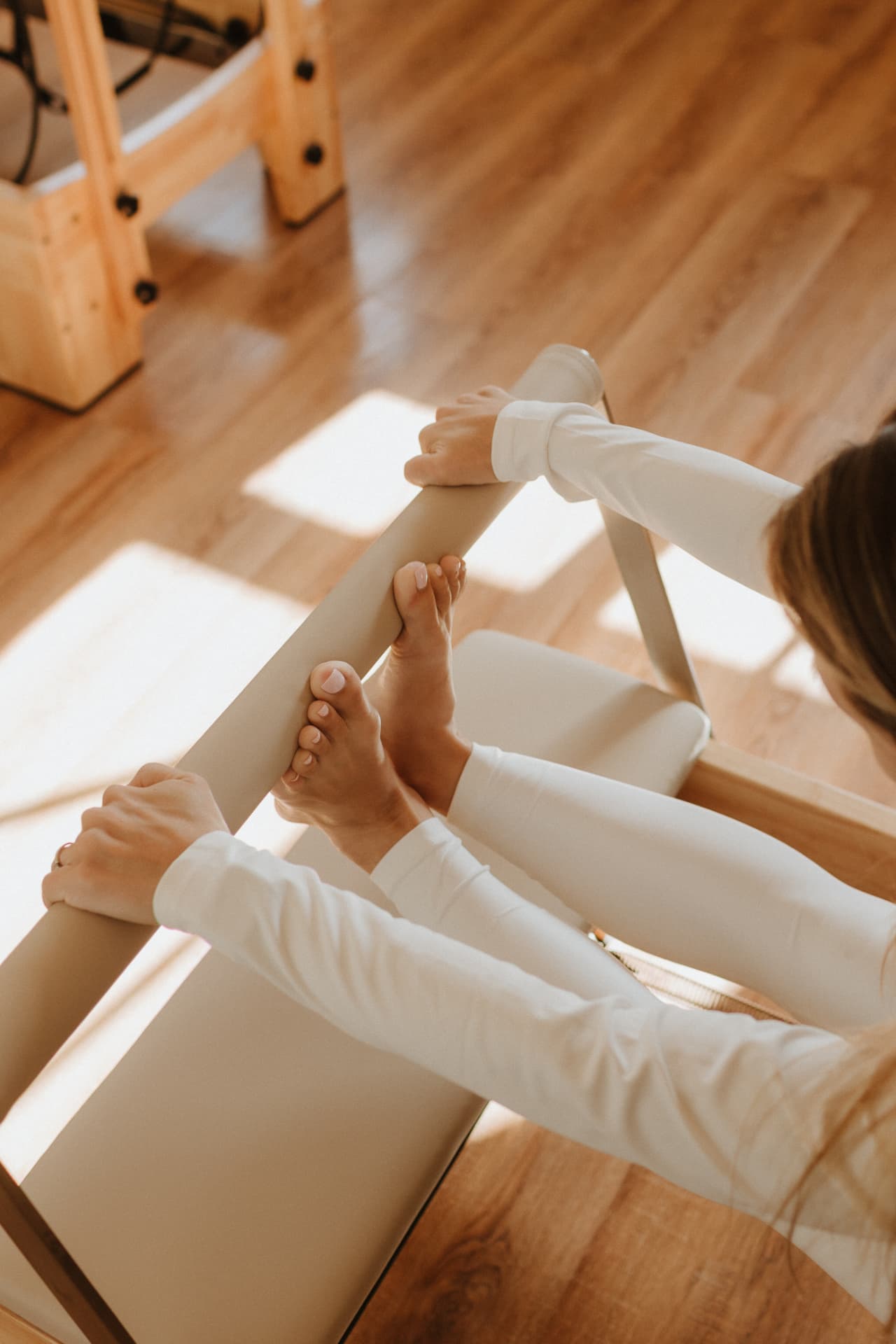 Feet and hands on the reformer footbar