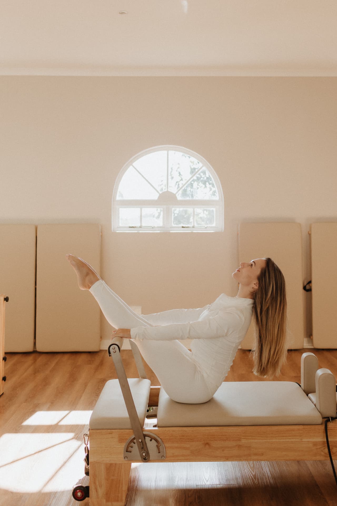 Teaser on the reformer beneath the arched window