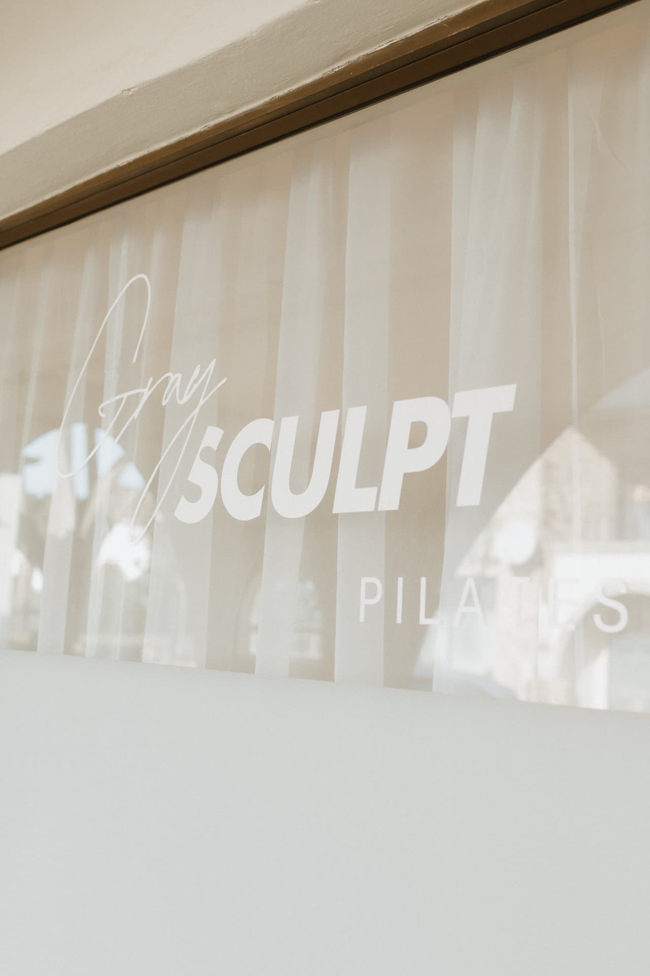 GraySculpt Pilates signage on the studio window